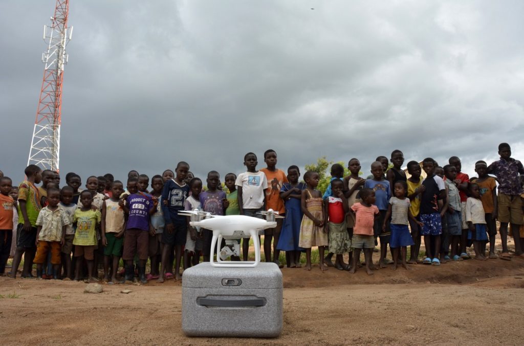 Children gather round to get a glimpse of the drone used by UNICEF for assessment © UNICEF Malawi/2017/Andrew Brown